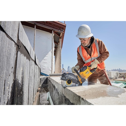 20 Volt to 60 Volt 9 AMP hours Lithium-Ion Battery-powered Circular Saw being used by a construction worker to cut concrete at a construction site