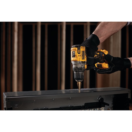 Brushless cordless drill/driver with battery in action.