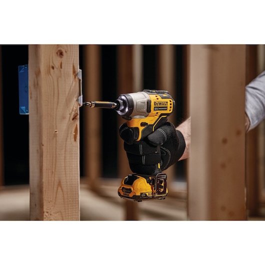 XTREME Brushless cordless impact driver being used on wooden beam.