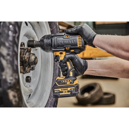 Impact Wrench removing lug nuts from a tire zoomed in.
