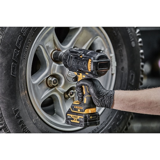 Impact Wrench removing lug nuts from a tire featuring the protective boot