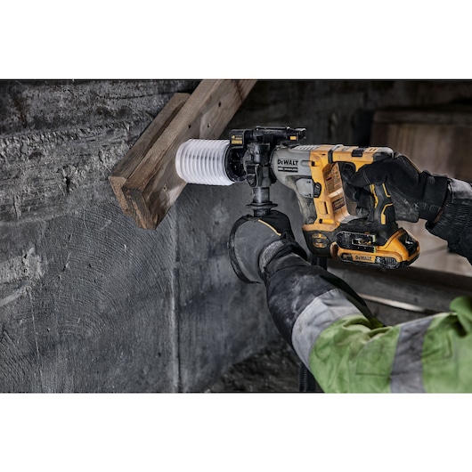 Atomic 20 volt five eighths inch brushless cordless S D S plus rotary hammer tool being used to hammer wood.
