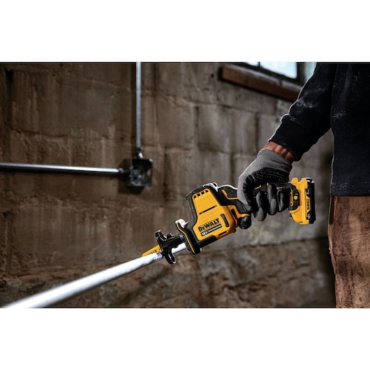 Brushless One-Handed Cordless Reciprocating Saw cutting pipe.
