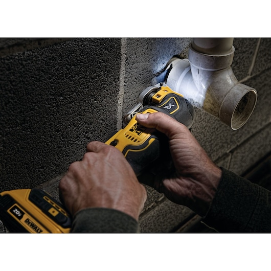 XR Cordless Oscillating Multi Tool being used by person to cut through a plumbing pipe