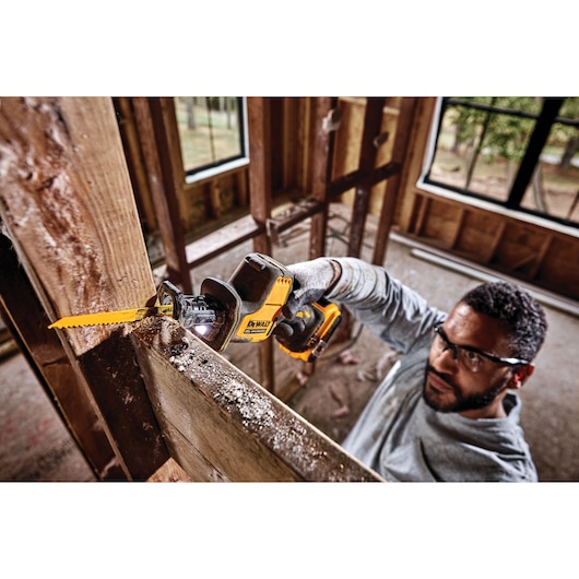 Overhead view of Cordless One Handed Reciprocating Saw being used by worker to cut through shiplap