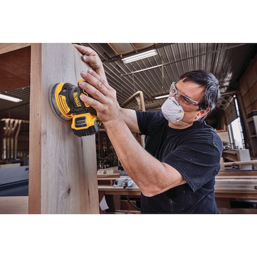 Brushless Cordless Variable Sheet Sander being used by a person.