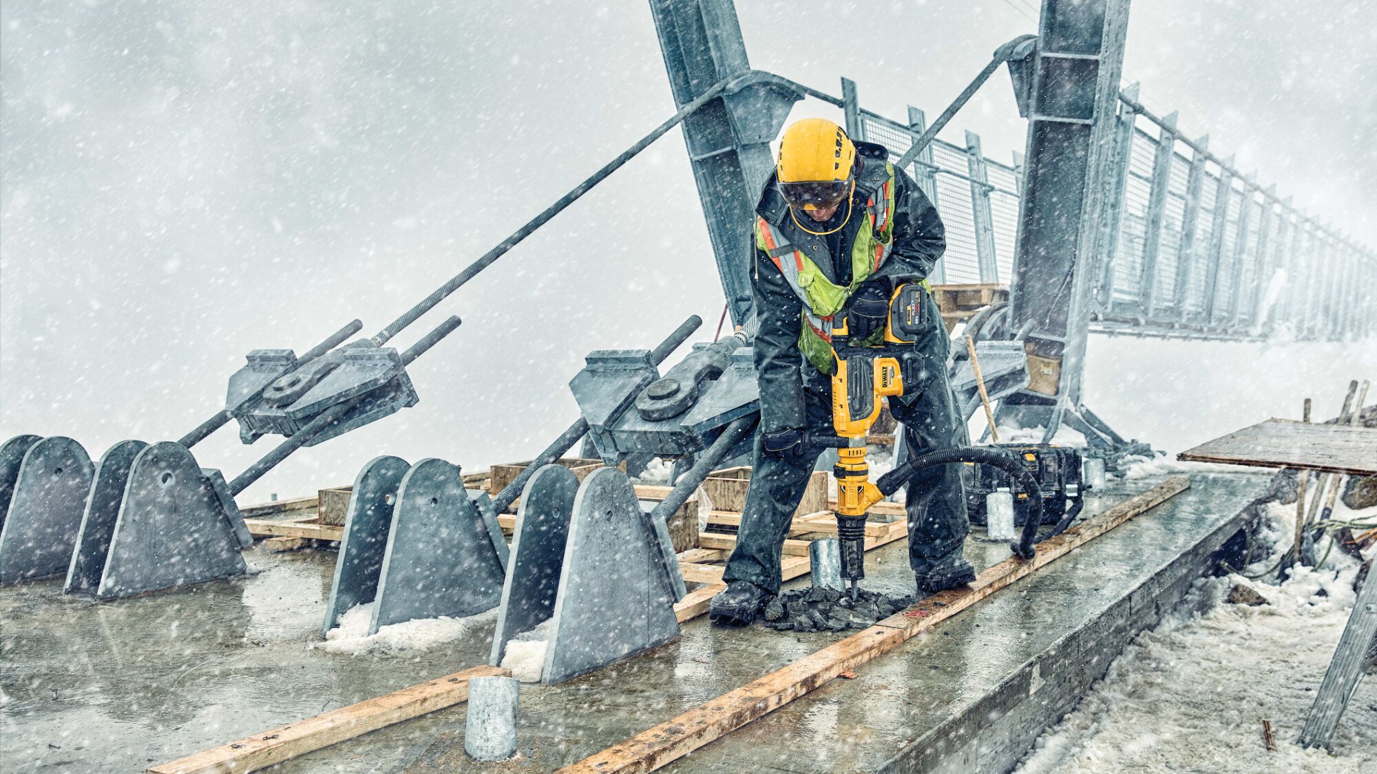 Brushless, cordless SDS MAX combination rotary hammer being used by a person in extreme conditions