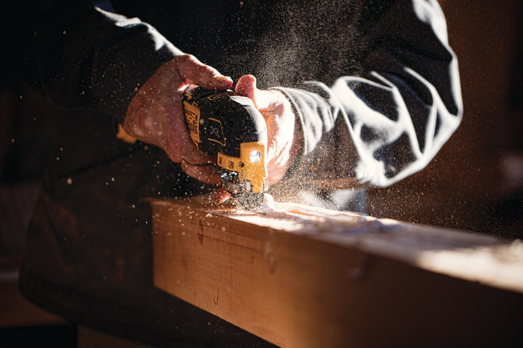 XR Cordless Oscillating Multi Tool being used by worker to slice through a square wooden log
