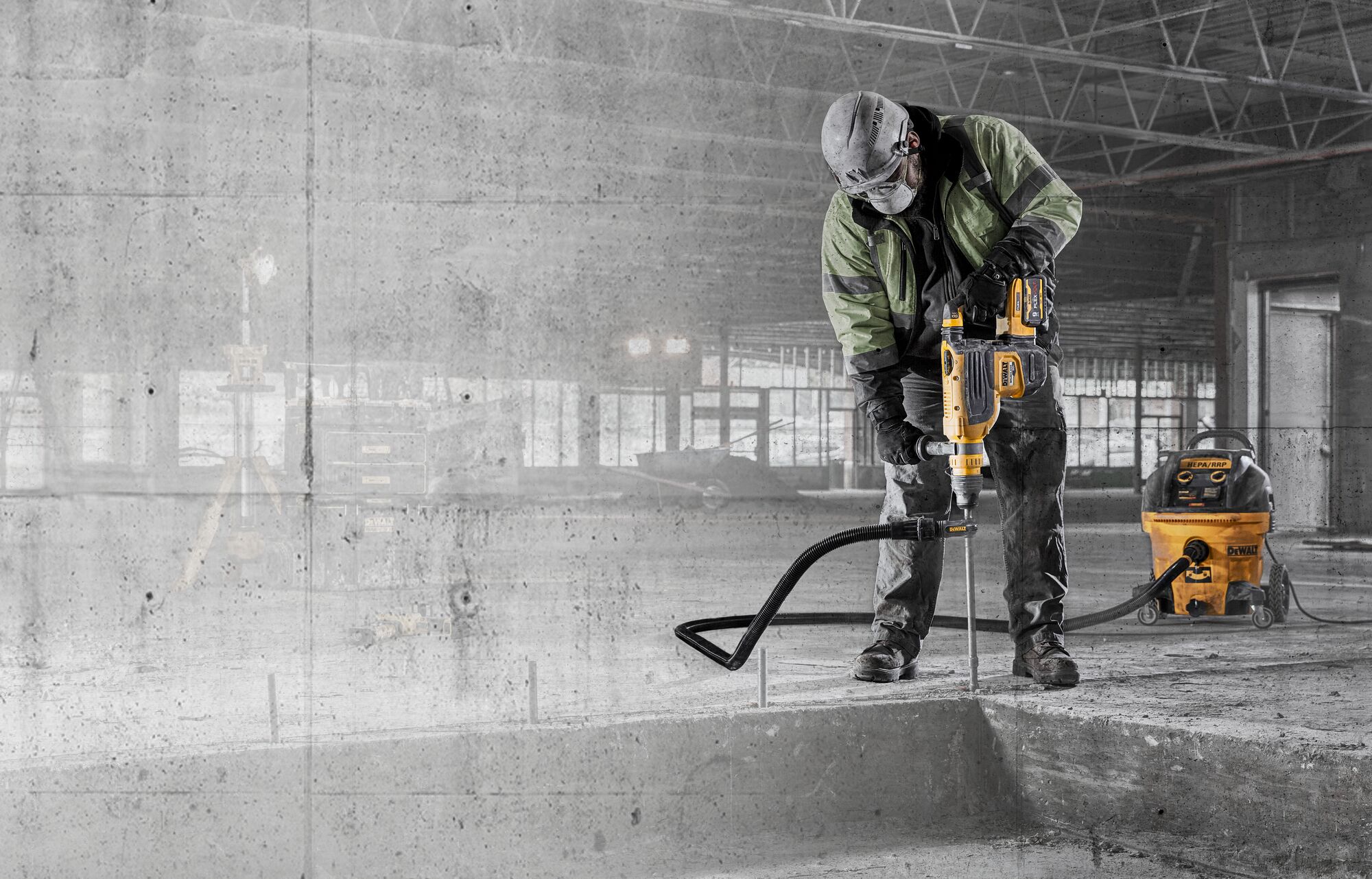Construction worker with 60V MAX 1-7/8 In. Brushless Cordless SDS MAX Combination Rotary Hammer and dust extraction drilling into concrete with graphic concrete texture overlay