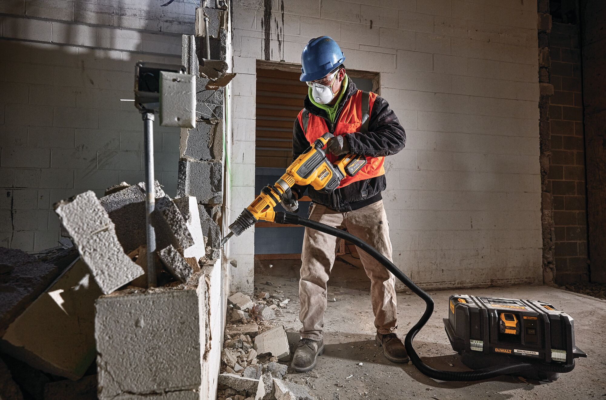Demolition hammer dust shroud chiseling being used by a person to chisel.