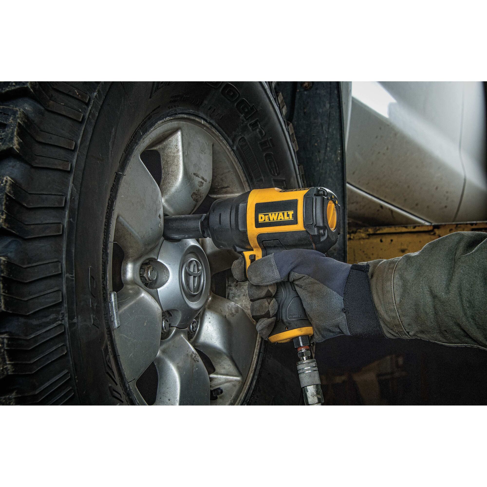 DEWALT half inch heavy duty drive impact wrench being used by a person.
