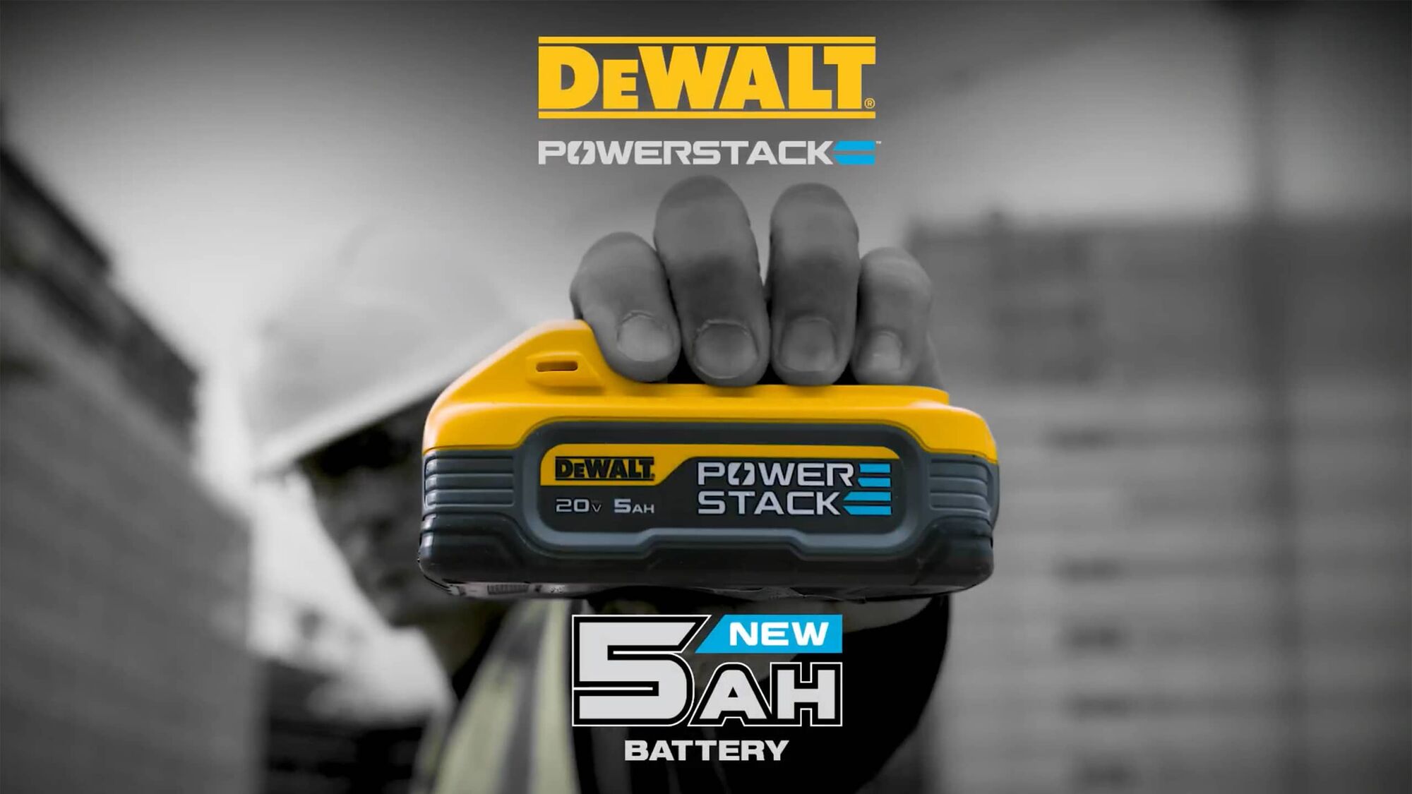 dewalt powerstack five amp hour battery held by a user on a jobsite with on screen text reading new five amp hour battery