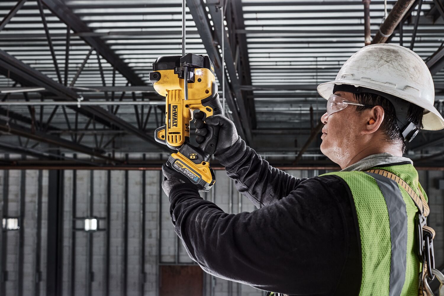DEWALT Threaded Rod Cutter is being used to cut threaded rod overhead by tradesman in a data center.