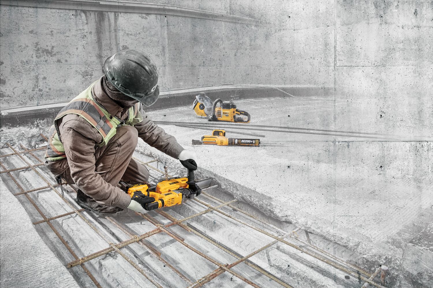 Man reinforceing concrete using Brushless SDS PLUS D-Handle rotary hammer with dust extraction