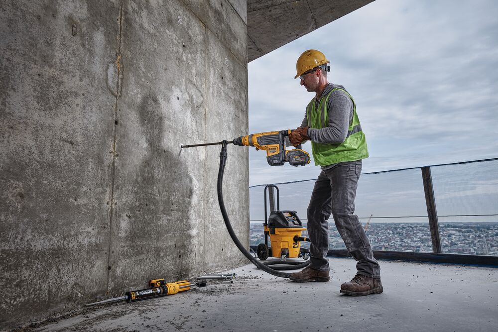 Brushless, cordless combination rotary hammer being used by a person