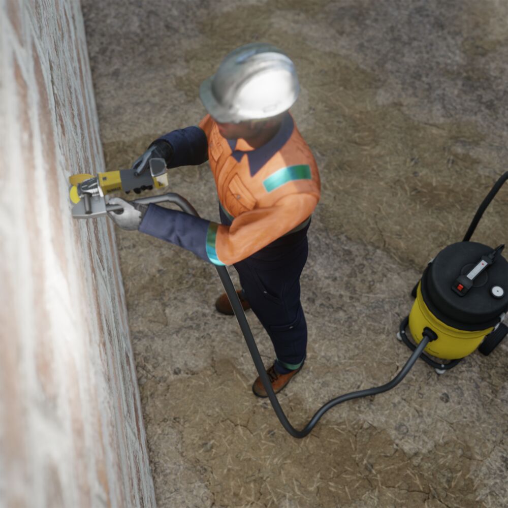 A mason grinding a line in a concrete wall