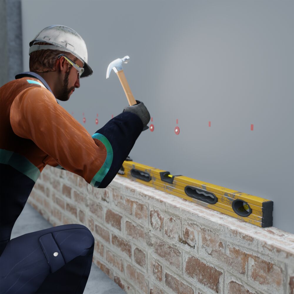 A mason using a level to construct a brick wall