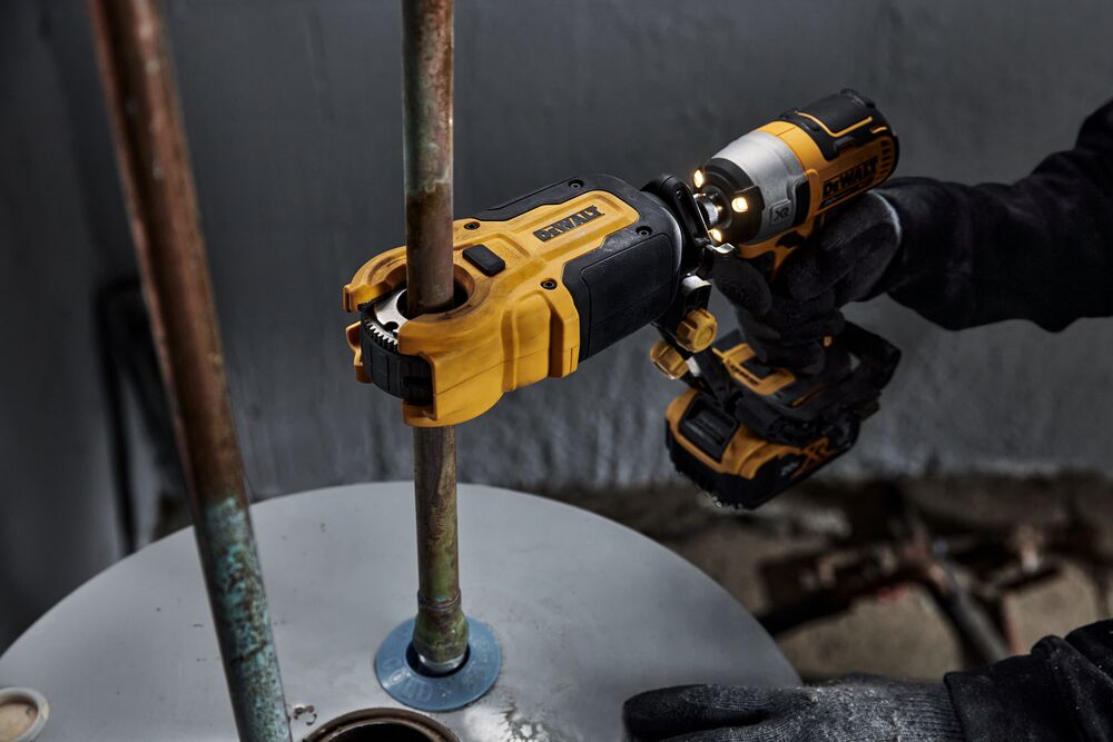 End user using DEWALT IMPACT CONNECT Copper Cutter attachment on Impact Driver to cut copper pipe.