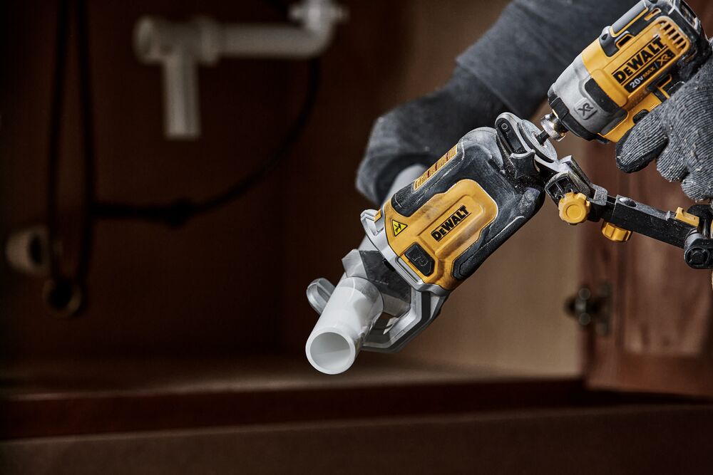 End user using DEWALT IMPACT CONNECT PVC/Pex Cutter attachment on Impact Driver to cut PVC pipe.