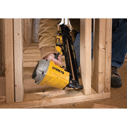 3 and a quarter Inch 21 Grade Collated Plastic Framing Nailer being used on a wooden structure.