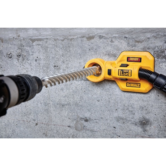 SDS Max High Impact Carbide 4 Cutter Drill Bit in use on concrete wall.