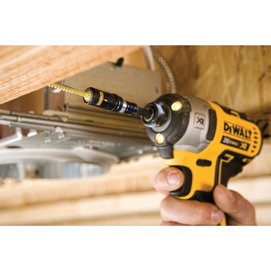 Flextorq Phillips impact driver bit being used by a person to drill a hole in wood.