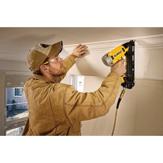 15 gauge Precision point DA style angle finish nailer being used by a person for crown molding.