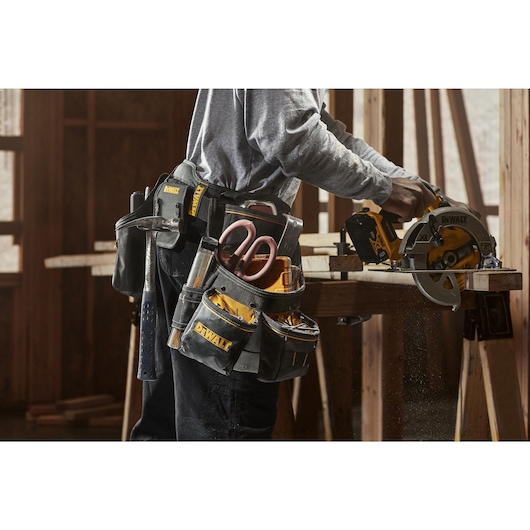 CONSTRUCTION WORKER WEARING DEWALT PROFESSIONAL IMPACT DRILL HOLSTER